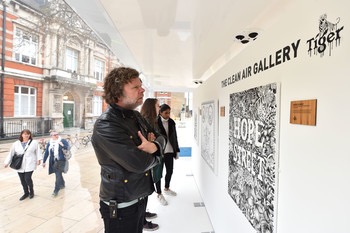 7063-Visitors_look_at_artworks_inside_the_Tiger_Beer_Clean_Air_Gallery_in_Brixton_London._The_works_were_created_using_Air_Ink_the_first_ink_to_be_made_from_air_pollution.JPG.350x0.jpg